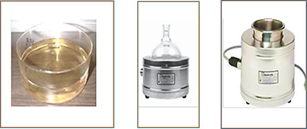 Three laboratory devices: a glass beaker containing yellow liquid, a heating mantle holding a round-bottom flask, and a standalone electric heating mantle, used for chemical heating processes.