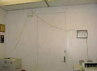 A 30 foot long extension cord draped over a door