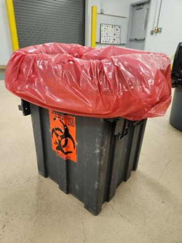 Picture of a grey biohazardous waste tub